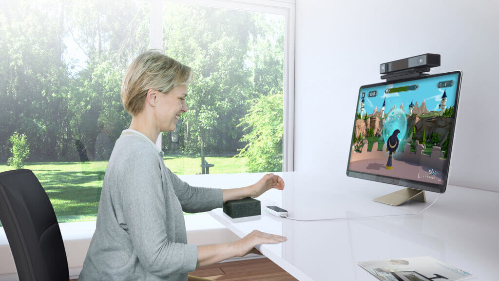 Woman doing arm exercises at a MindMaze MindMotion GO screen with a motion-tracking camera